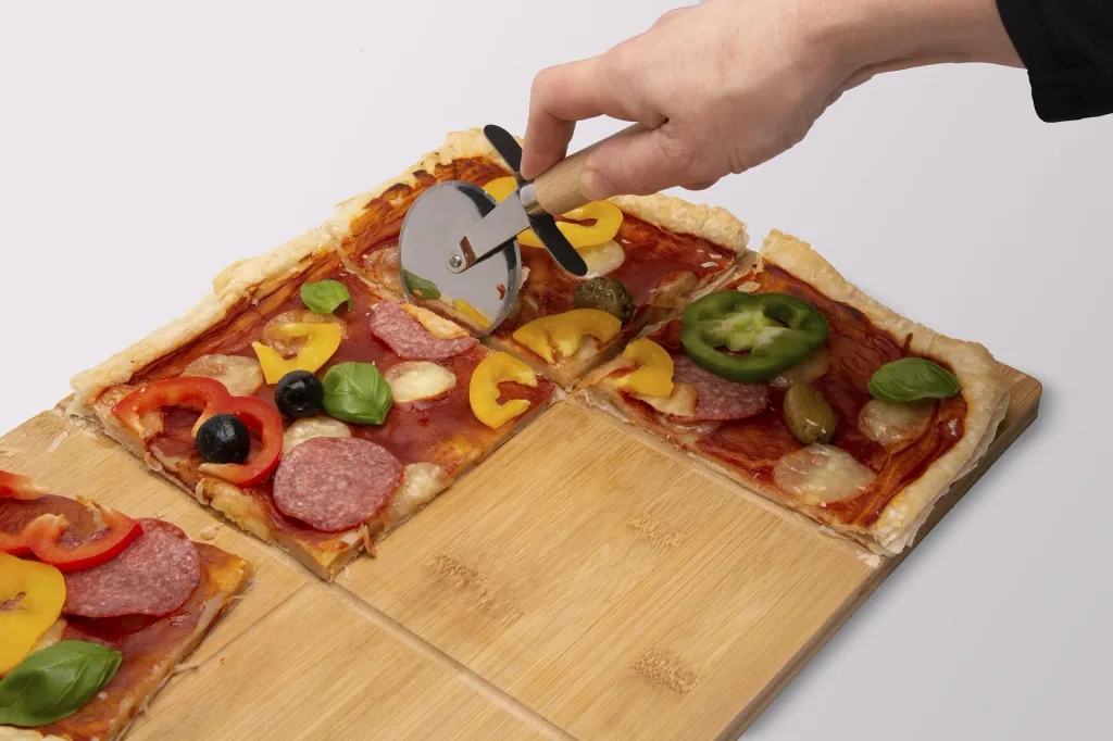 Pizza cutting board with pizza cutter