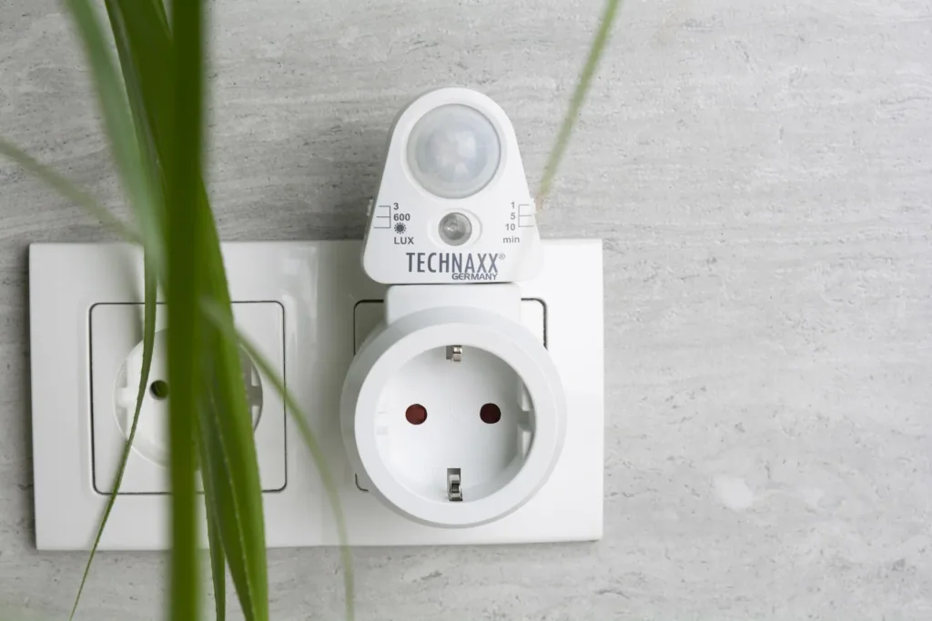 Socket adapter with motion detector and light sensor