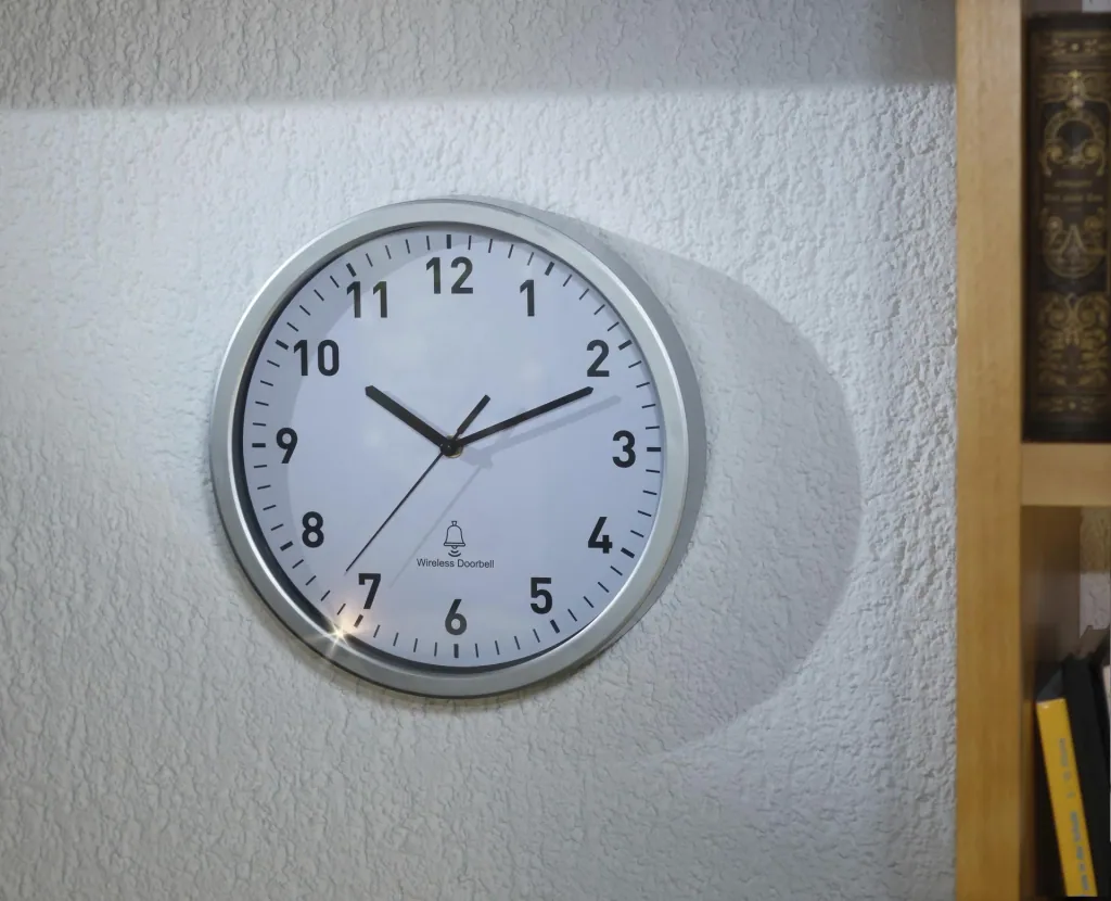 Radio-controlled wall clock with doorbell