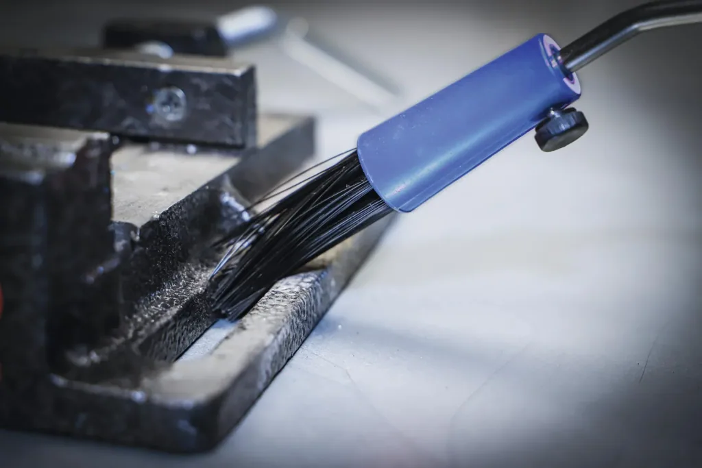 Compressed air blow gun with brush